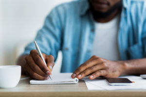 man writing his life story